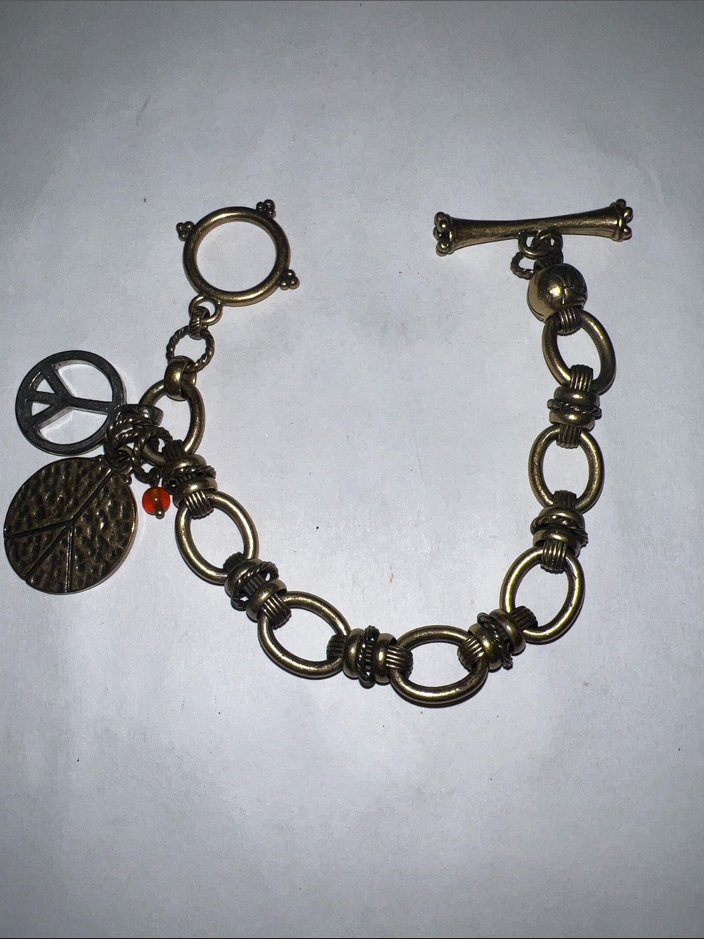 Lucky  Brand Bronze Tone Charm Toggle Bracelet with Peace Charms
